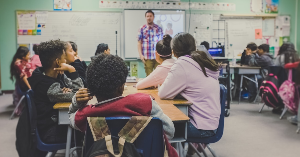 Students learning in a modern classroom with digital technology