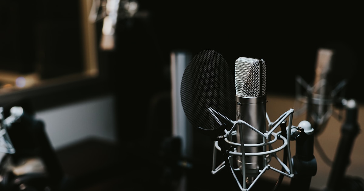 Professional microphone in a recording studio with warm lighting